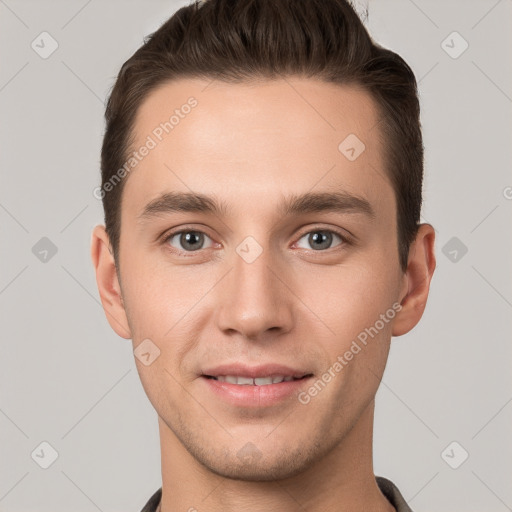 Joyful white young-adult male with short  brown hair and grey eyes