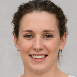 Joyful white adult female with short  brown hair and grey eyes