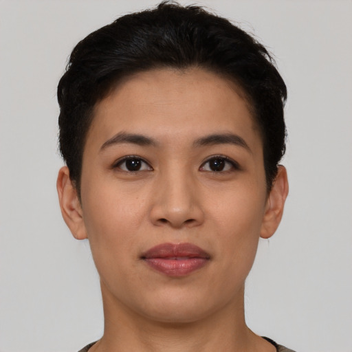 Joyful latino young-adult female with short  brown hair and brown eyes