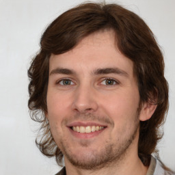 Joyful white young-adult male with medium  brown hair and brown eyes