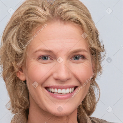 Joyful white adult female with medium  brown hair and blue eyes