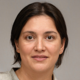 Joyful white adult female with medium  brown hair and brown eyes