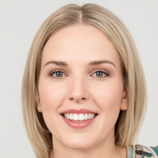 Joyful white young-adult female with medium  brown hair and green eyes