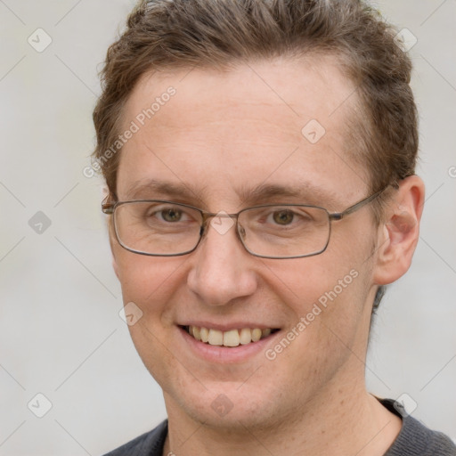 Joyful white adult male with short  brown hair and grey eyes