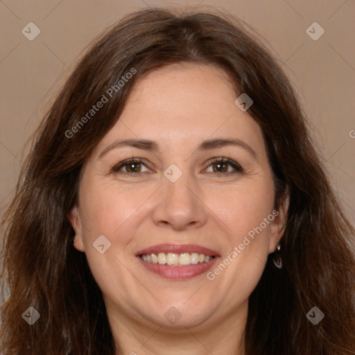 Joyful white adult female with long  brown hair and brown eyes