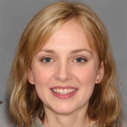 Joyful white young-adult female with medium  brown hair and blue eyes