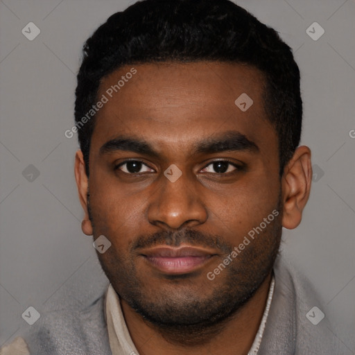 Joyful black young-adult male with short  brown hair and brown eyes