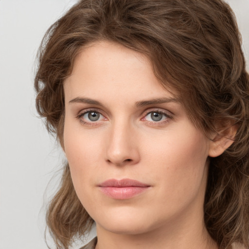 Joyful white young-adult female with medium  brown hair and green eyes