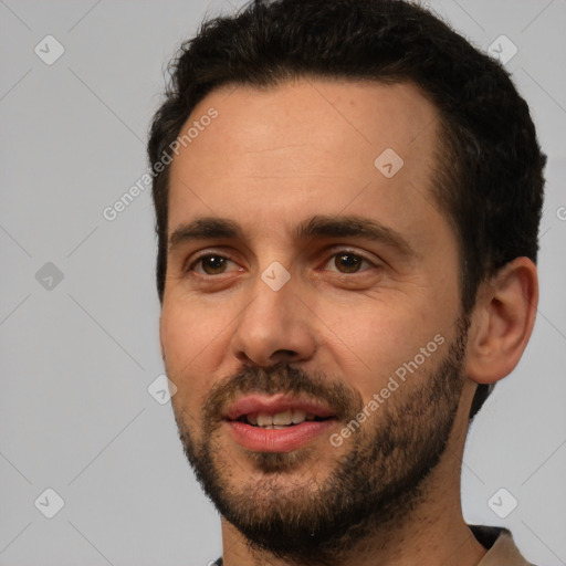 Joyful white young-adult male with short  black hair and brown eyes