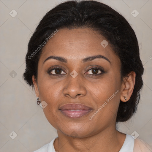 Joyful black adult female with medium  brown hair and brown eyes