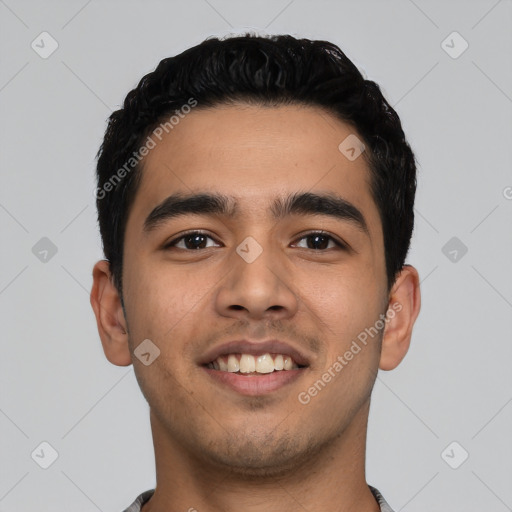 Joyful latino young-adult male with short  black hair and brown eyes