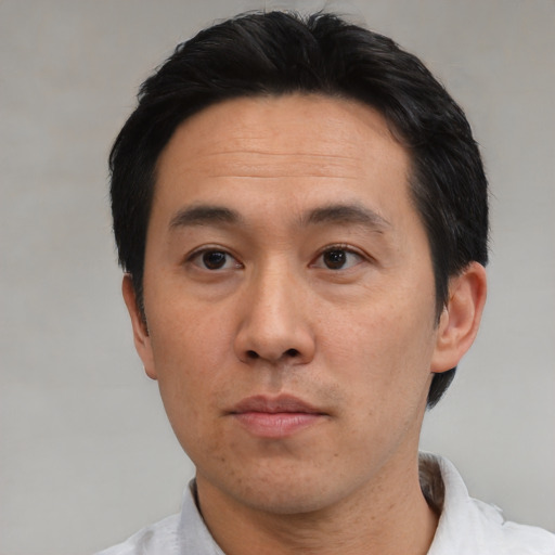 Neutral asian adult male with short  black hair and brown eyes