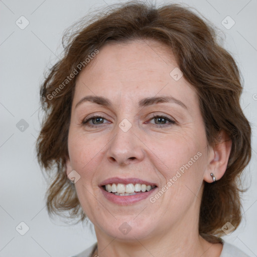 Joyful white adult female with medium  brown hair and grey eyes