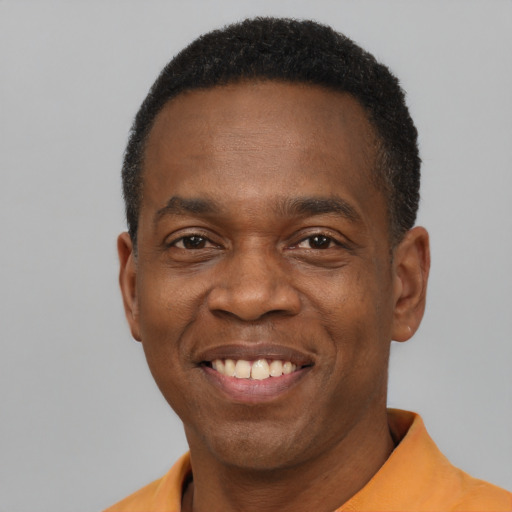 Joyful latino adult male with short  brown hair and brown eyes