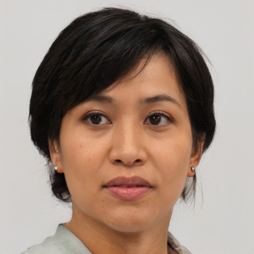 Joyful asian adult female with medium  brown hair and brown eyes