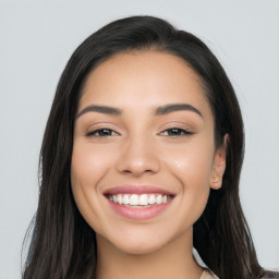 Joyful white young-adult female with long  black hair and brown eyes