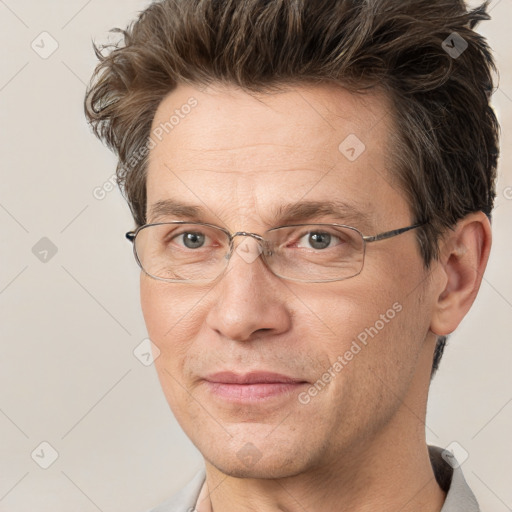 Joyful white adult male with short  brown hair and grey eyes