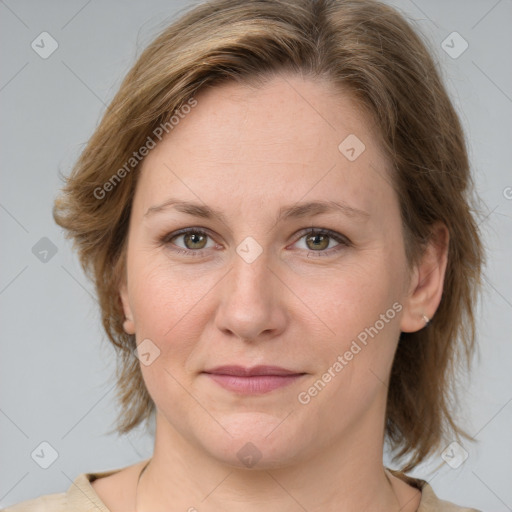 Joyful white adult female with medium  brown hair and green eyes