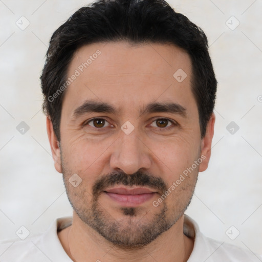 Joyful white adult male with short  black hair and brown eyes