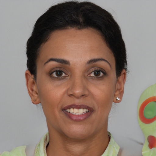 Joyful latino young-adult female with short  brown hair and brown eyes