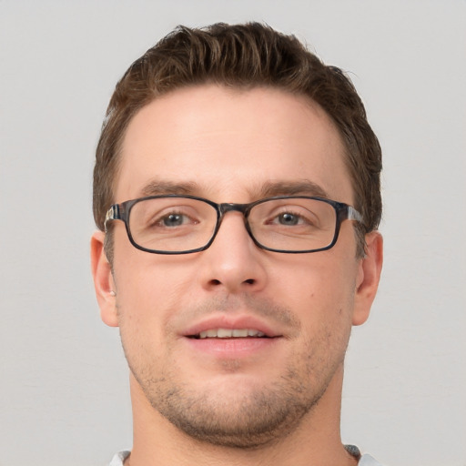 Joyful white young-adult male with short  brown hair and grey eyes