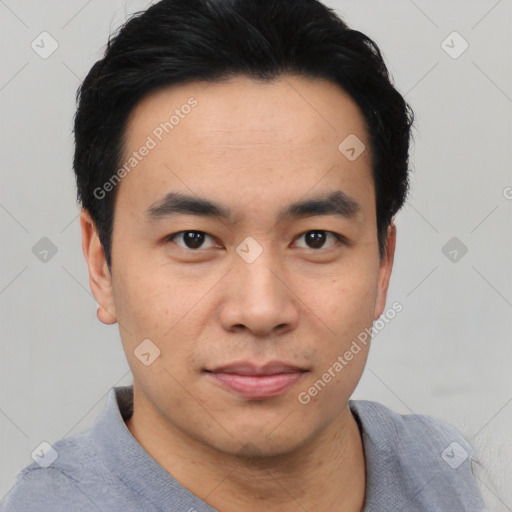 Joyful asian young-adult male with short  black hair and brown eyes