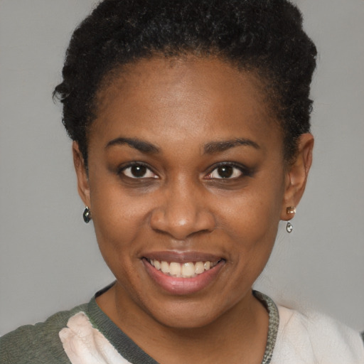 Joyful black young-adult female with short  brown hair and brown eyes