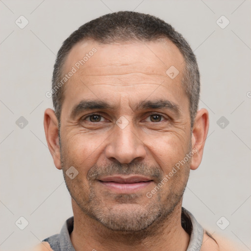 Joyful white adult male with short  black hair and brown eyes