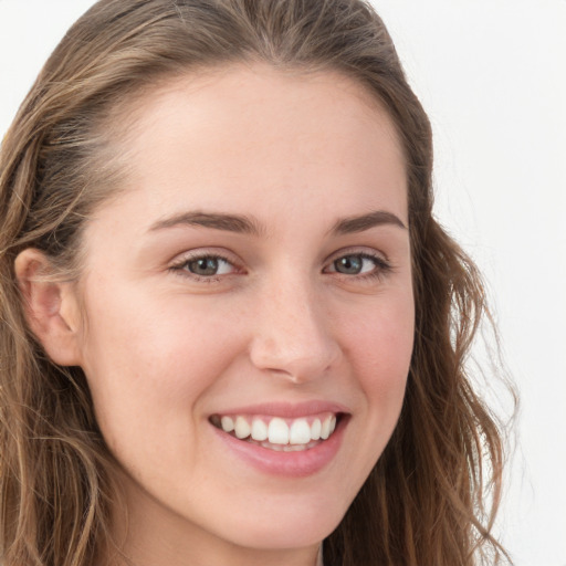 Joyful white young-adult female with long  brown hair and blue eyes