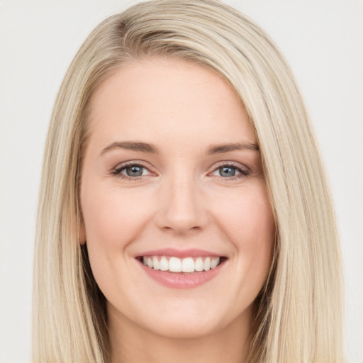 Joyful white young-adult female with long  brown hair and blue eyes