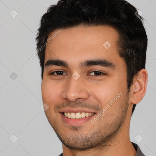 Joyful white young-adult male with short  black hair and brown eyes