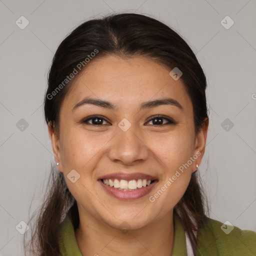 Joyful latino young-adult female with long  brown hair and brown eyes