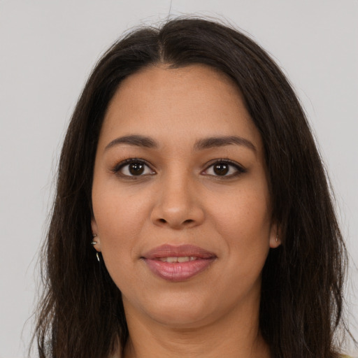 Joyful latino young-adult female with long  brown hair and brown eyes