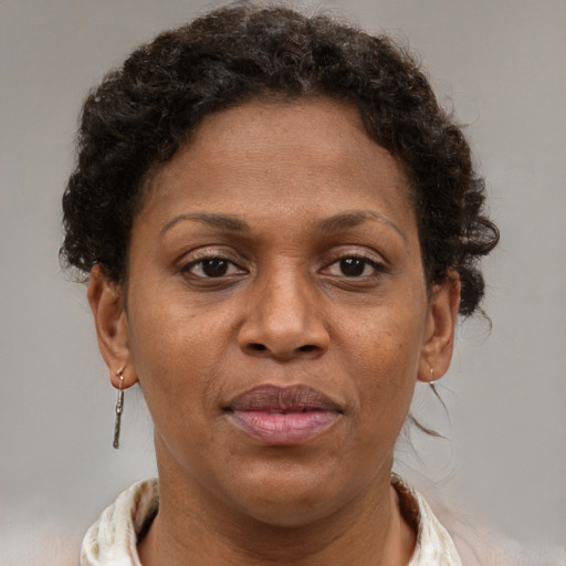 Joyful black adult female with short  brown hair and brown eyes