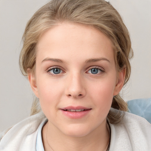 Joyful white young-adult female with medium  brown hair and blue eyes