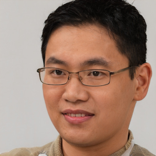 Joyful asian young-adult male with short  brown hair and brown eyes
