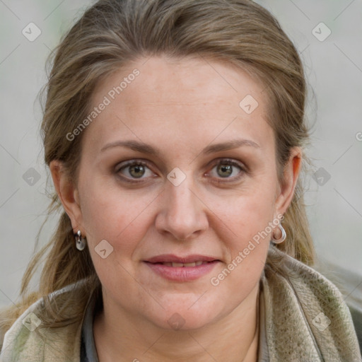 Joyful white adult female with medium  brown hair and blue eyes