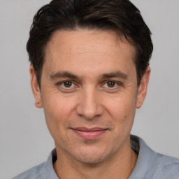 Joyful white adult male with short  brown hair and brown eyes