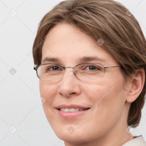 Joyful white adult female with medium  brown hair and grey eyes