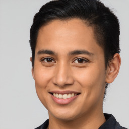 Joyful latino young-adult male with short  brown hair and brown eyes