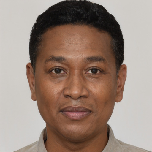 Joyful latino adult male with short  black hair and brown eyes