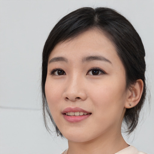 Joyful asian young-adult female with medium  black hair and brown eyes