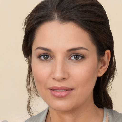 Joyful white young-adult female with medium  brown hair and brown eyes