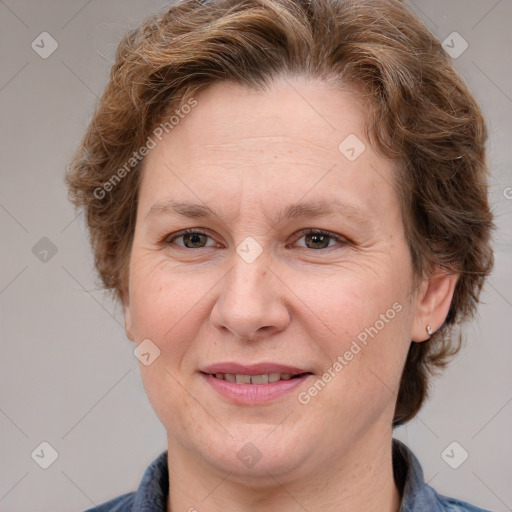 Joyful white adult female with medium  brown hair and blue eyes