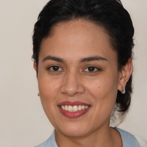 Joyful latino young-adult female with short  brown hair and brown eyes