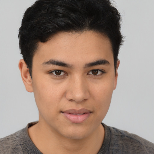 Joyful asian young-adult male with short  brown hair and brown eyes