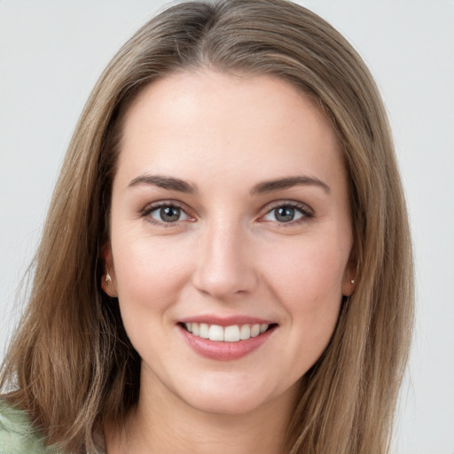 Joyful white young-adult female with long  brown hair and grey eyes