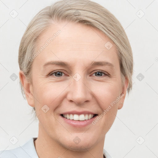 Joyful white young-adult female with medium  brown hair and blue eyes