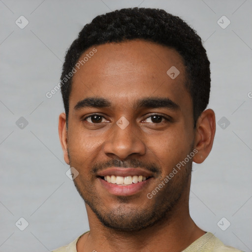 Joyful black young-adult male with short  black hair and brown eyes