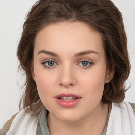 Joyful white young-adult female with medium  brown hair and green eyes